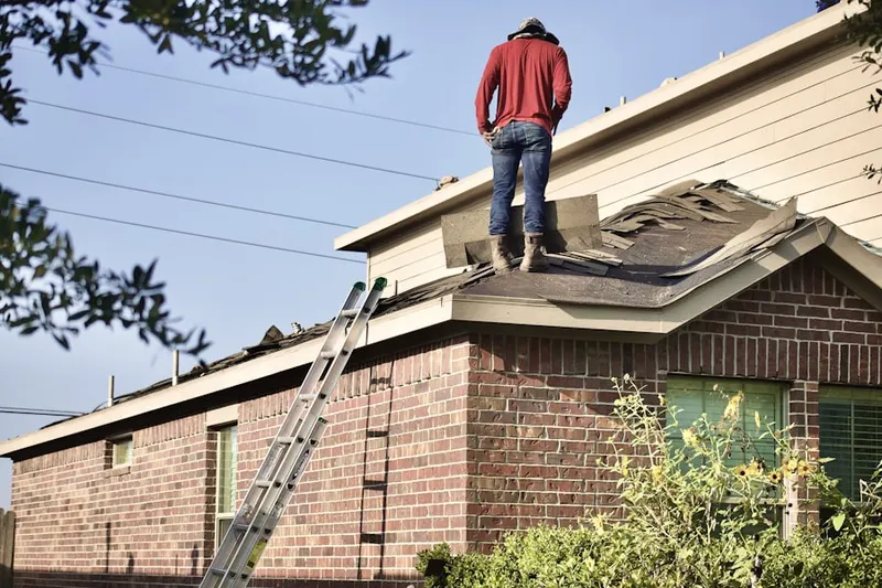 Professional roofer working on a residential roof in Oakleaf Plantation